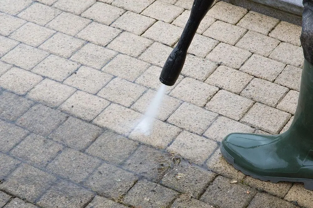 Pressure washer lance cleaning block paving